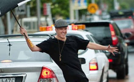 Travers Ross dances in the rain at Coffs city centre. Travers Ross dances in the rain at Coffs city centre.